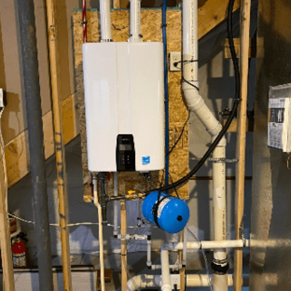 Tankless water heater mounted on support beam